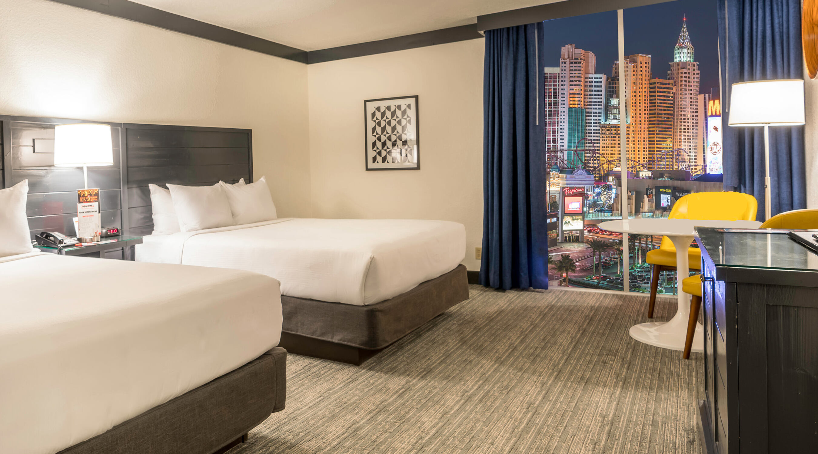 Two queen bed next to window with Strip view