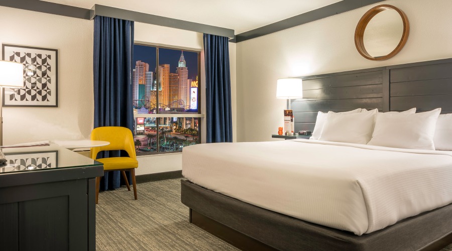 One king bed, TV on armoire and window with sheers drawn